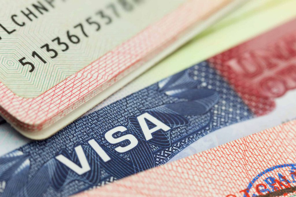 Refugee documents - USA visa in a passport background