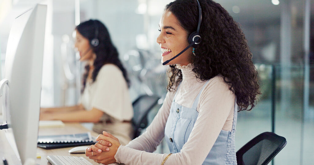 An image of an travel provider in an office talking to a traveller on the phone