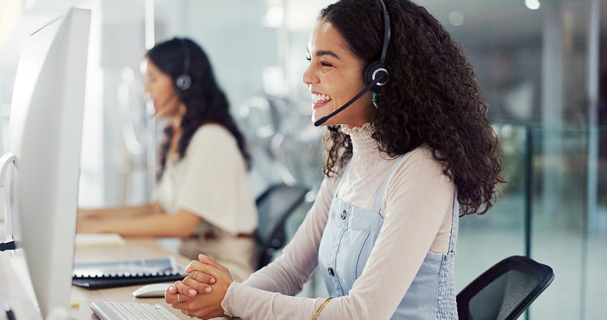 An image of an travel provider in an office talking to a traveller on the phone