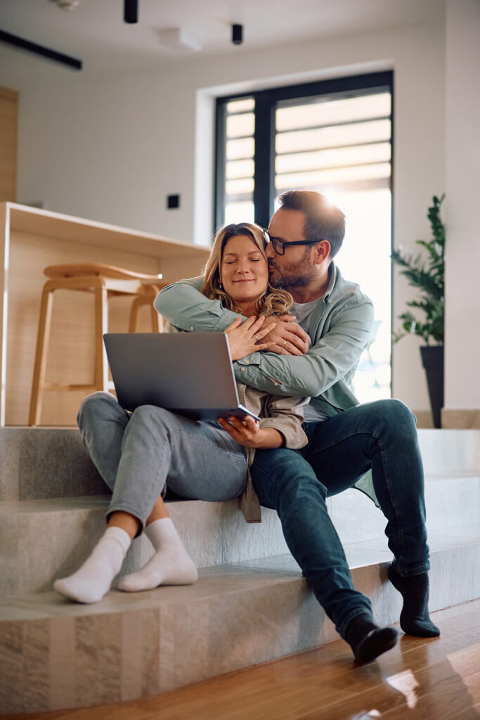 An image of a happy couple booking a holiday online