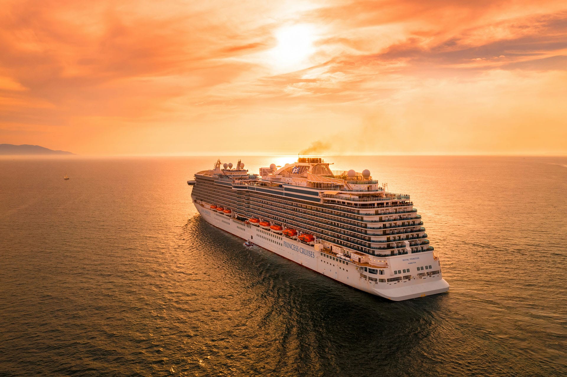 A cruise ship heading into the sunset