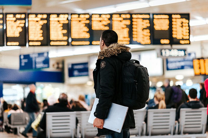 A traveller checking departure boards at an airport
