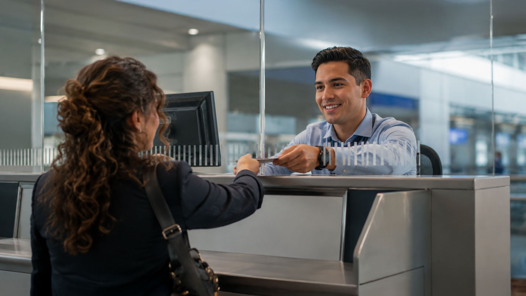 A female business traveller talking to an airport security official